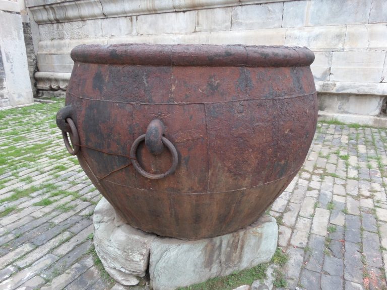 Large bronze fire cauldron beside a Forbidden City hall