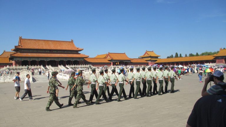 Summer visitors and bright sun inside the Forbidden City palace courtyards