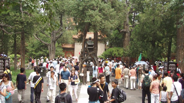 Visitors walking through the Imperial Garden at the Forbidden City
