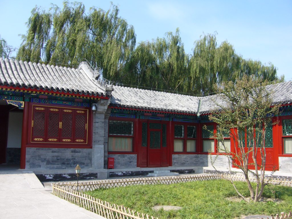 Red doors and willow trees in a Prince Gong Mansion courtyard