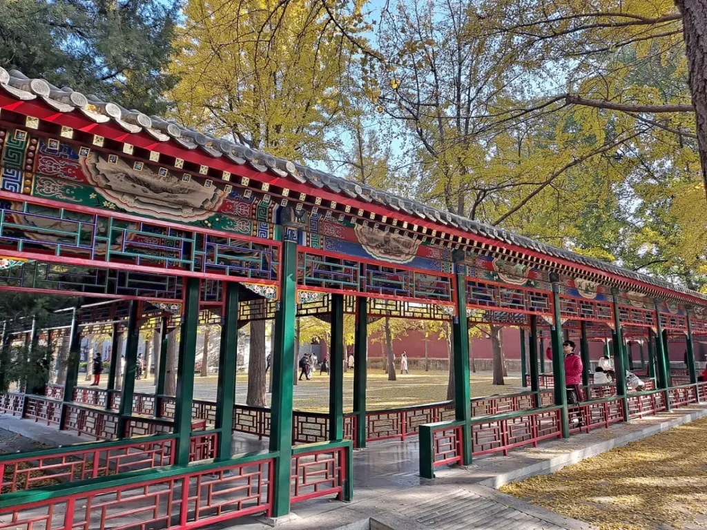 Painted covered corridor with autumn trees in Zhongshan Park