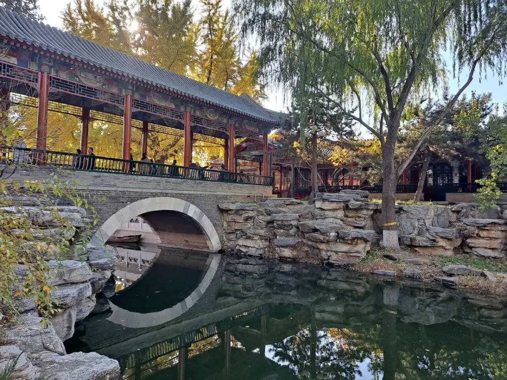 Stone arch bridge, water, and garden pavilion in Zhongshan Park